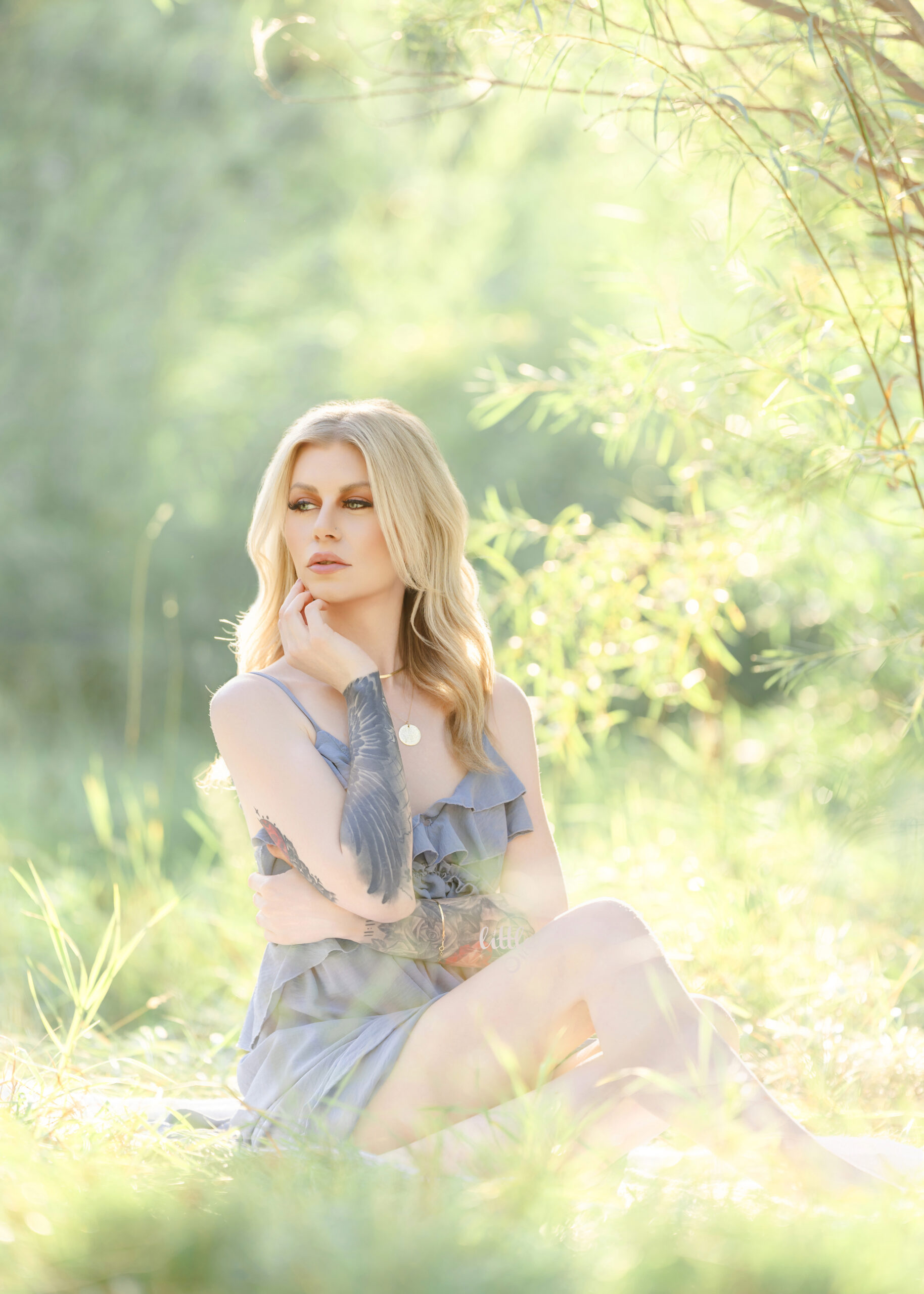 girl sitting on a blanket surrounded by greenery in Edmonton.