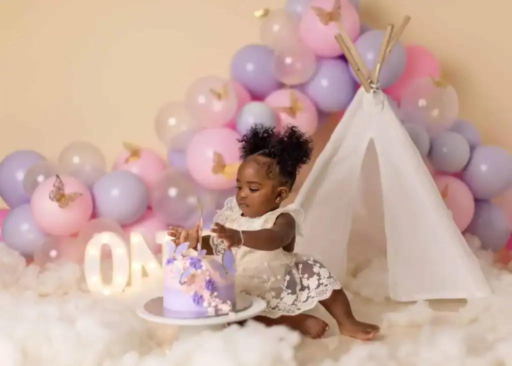 Pink floral Edmonton cake smash setup for a baby girl’s first birthday with soft pastel tones and fresh cakes.