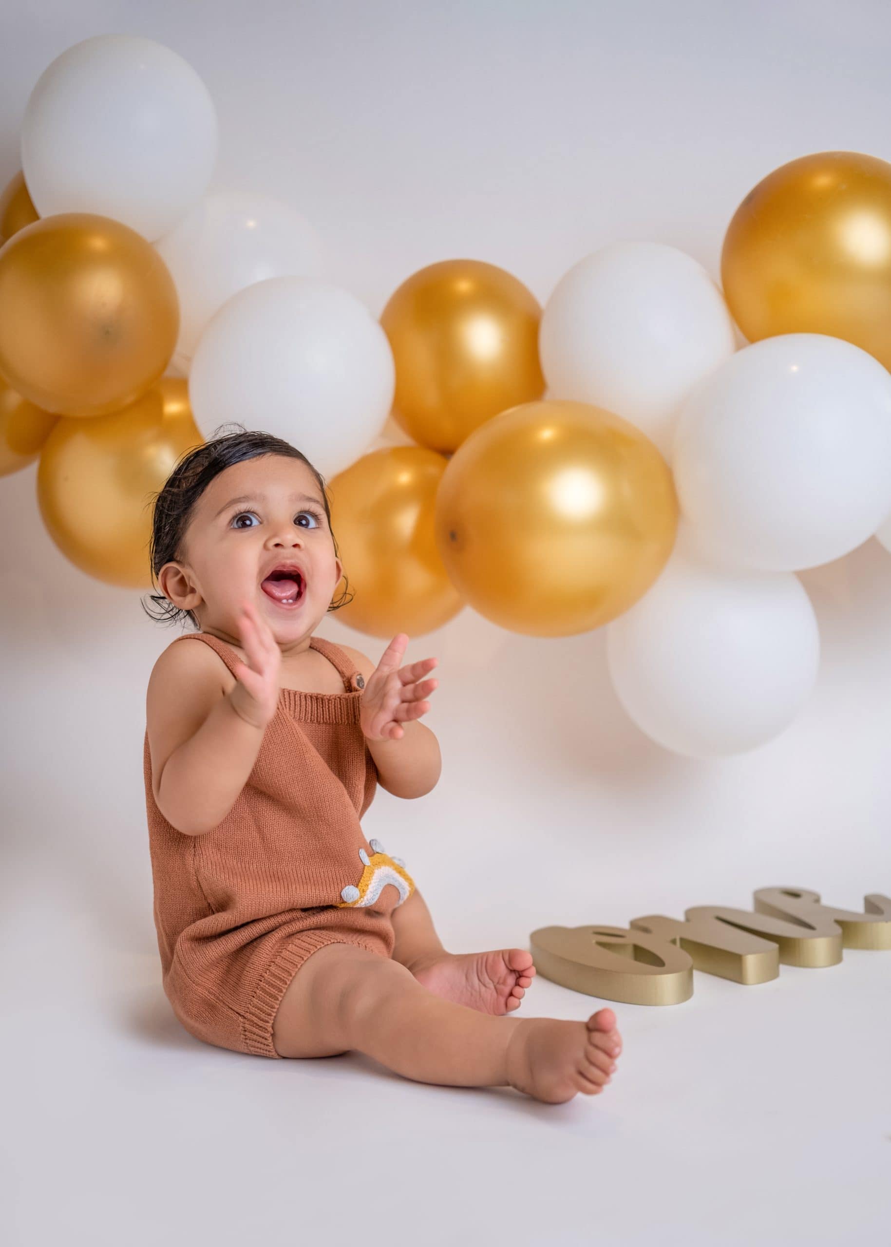 golden and white cake smash theme for 1-year-old baby