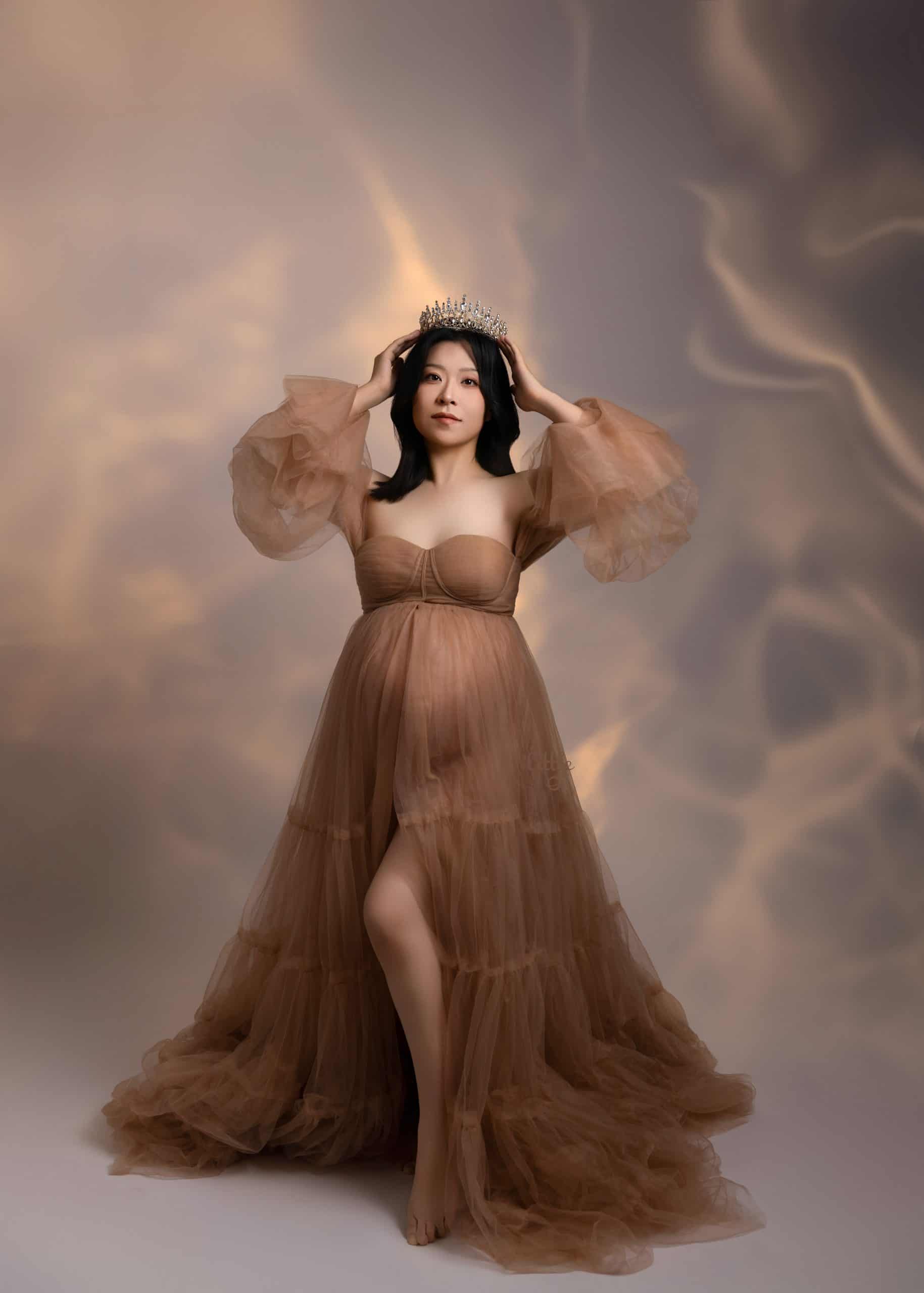 Pregnant woman wearing a luxury gown during a maternity photoshoot in Edmonton
