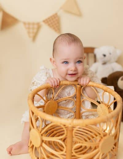 1-year-old baby girl in her cake smash set up to celebrat her first birthday.