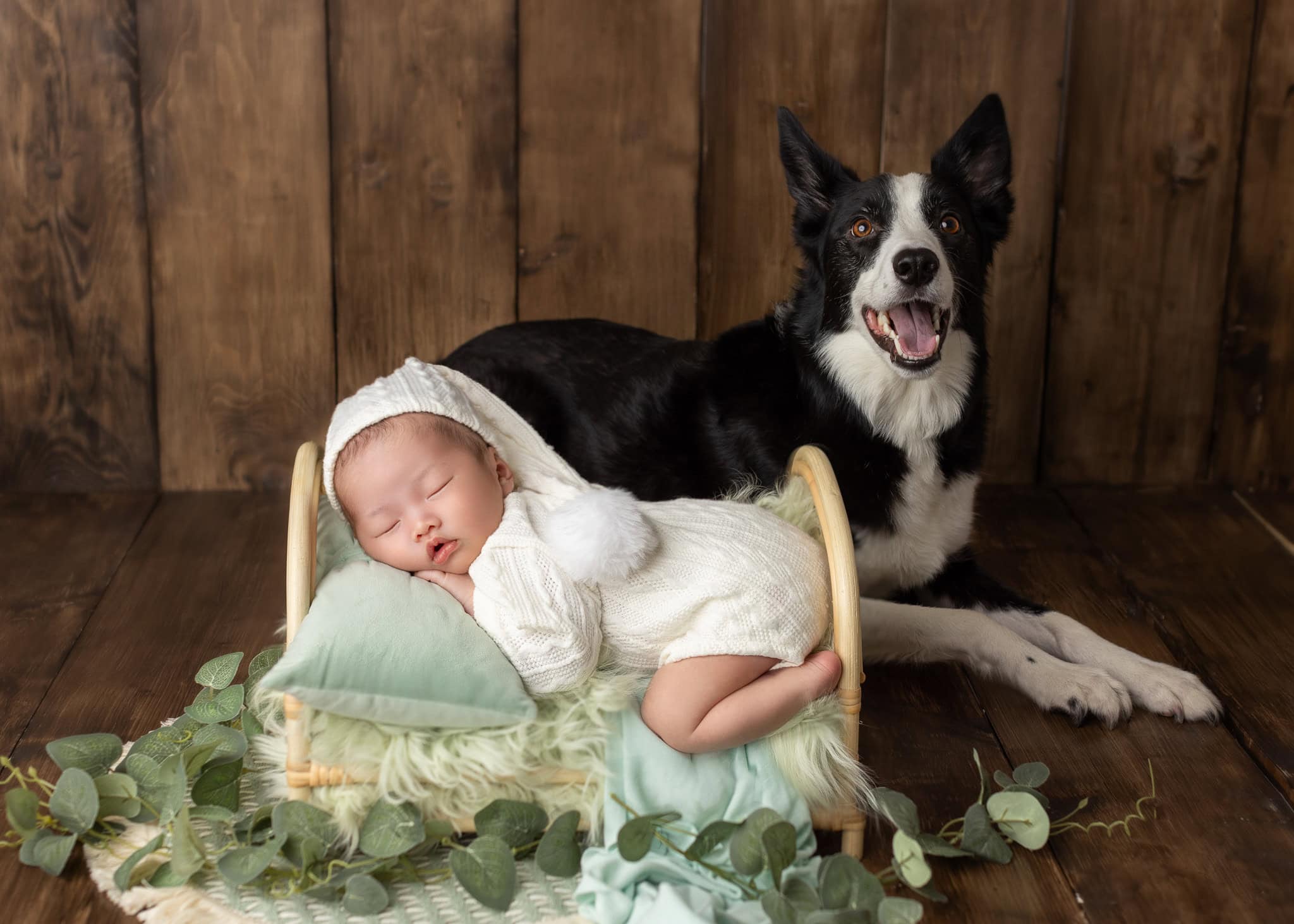newborn posed on his prop bed with his god in Edmonton Newborn Photography Studio