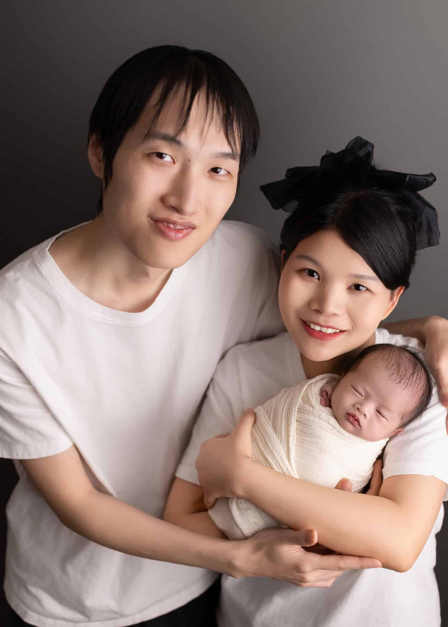 Paretns holding their newborn baby for family photoshoot with newborn in Edmonton