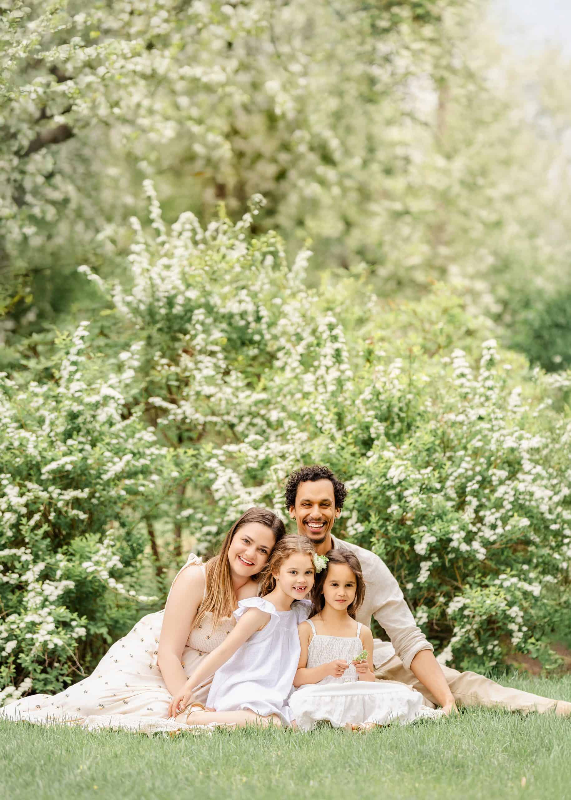 Spring family photo in blooming garden setting in Edmonton