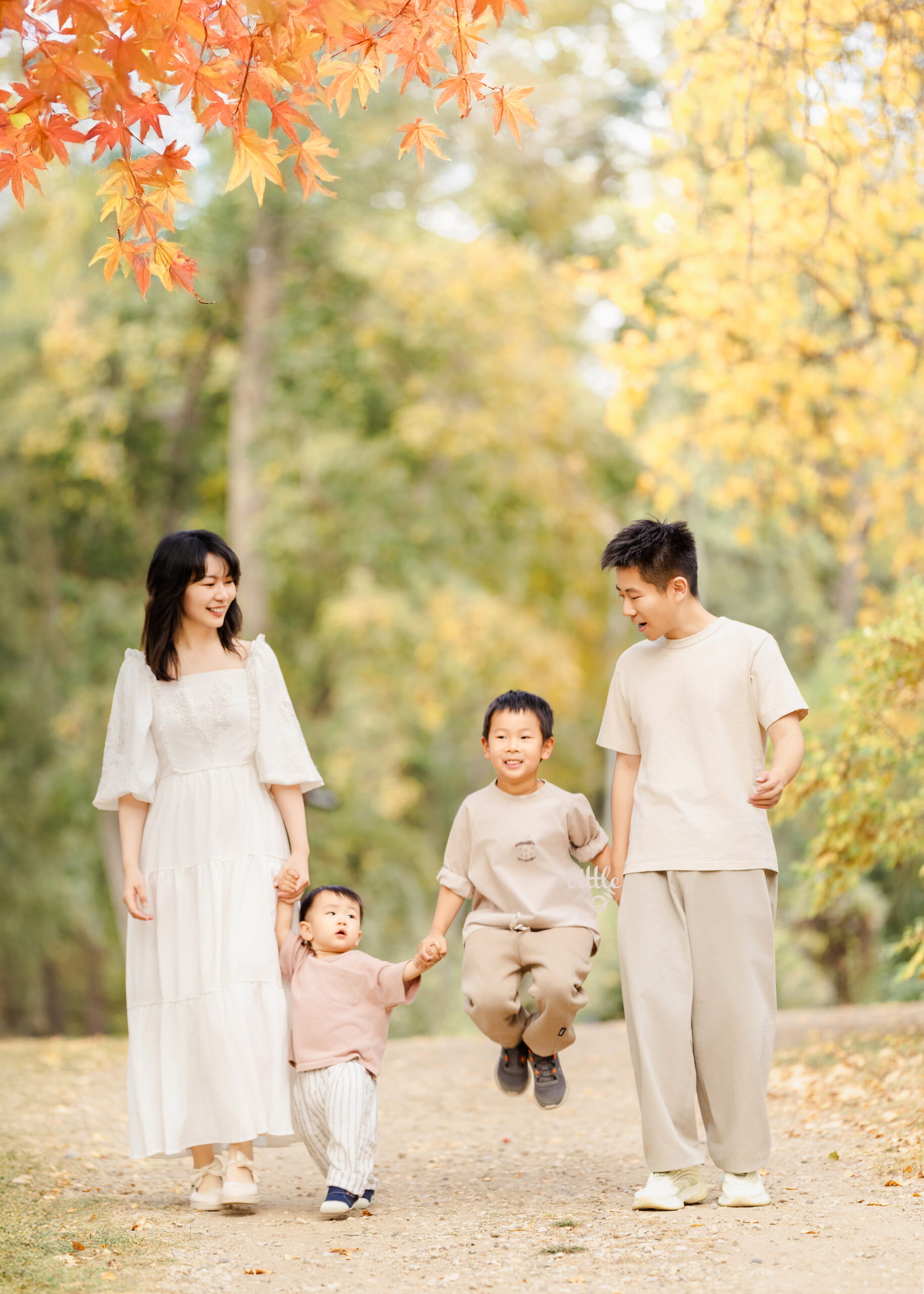 Parents walking hand in hand with their children during an Edmonton sunset family session.