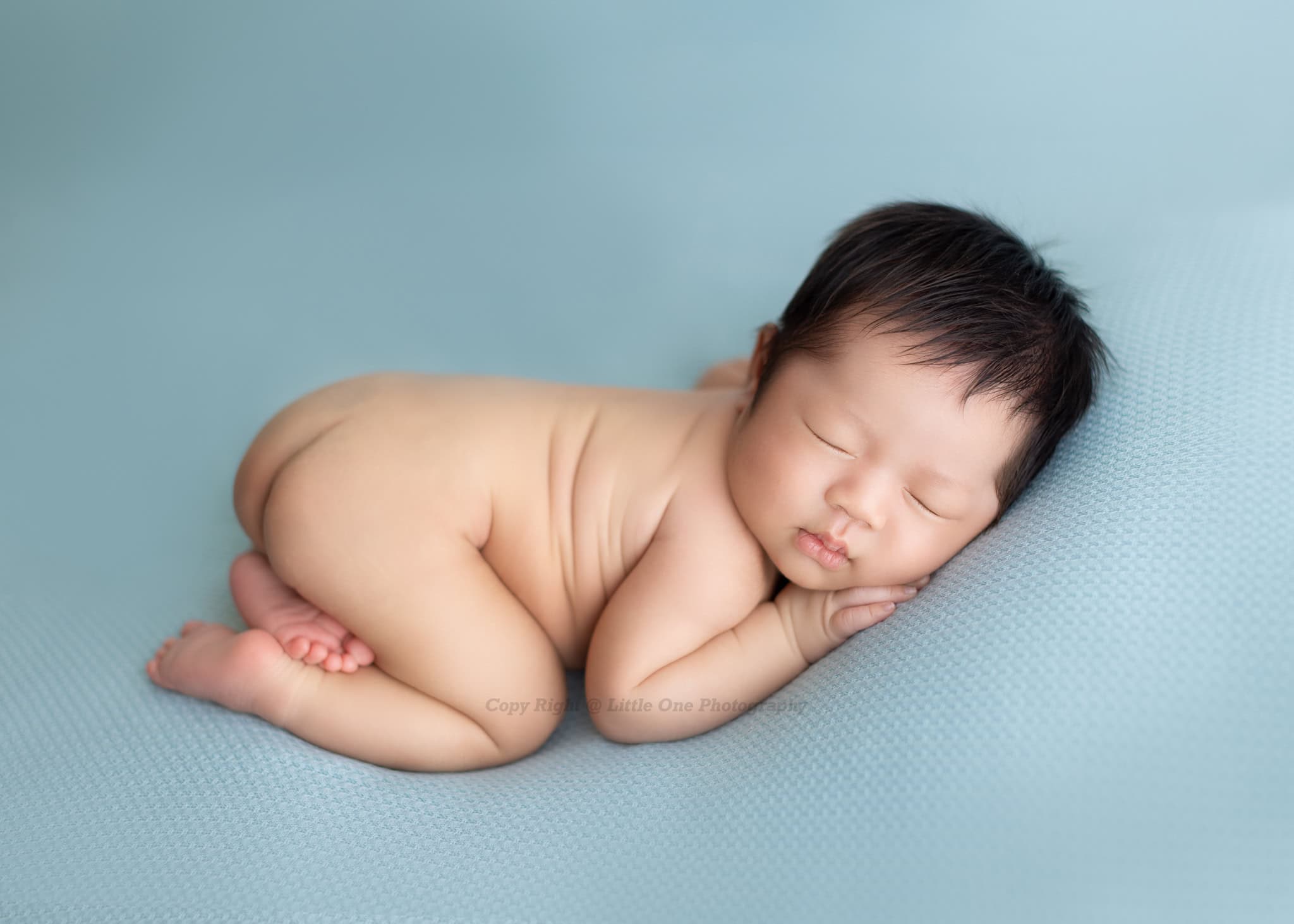 Timeless newborn photo in soft neutral tones by an Edmonton photography studio