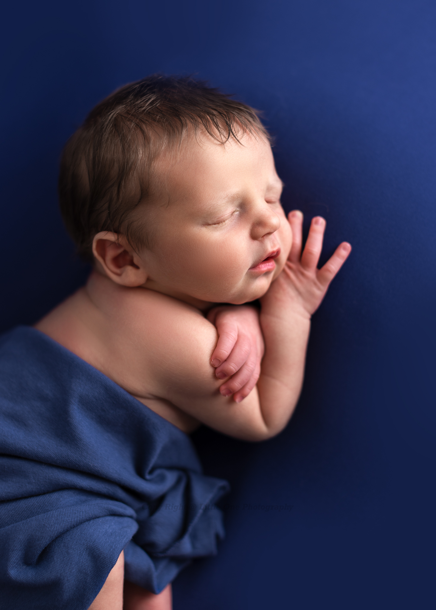 Artistic newborn portrait highlighting delicate features and gentle textures