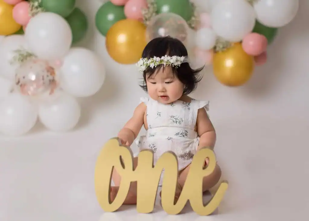 Baby playing prop in a cake smash session in an Edmonton photography studio