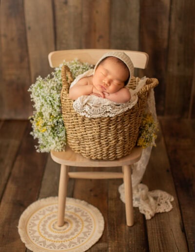 Newborn photo taken in Edmonton with baby sleep in a basket, classic and timeless style