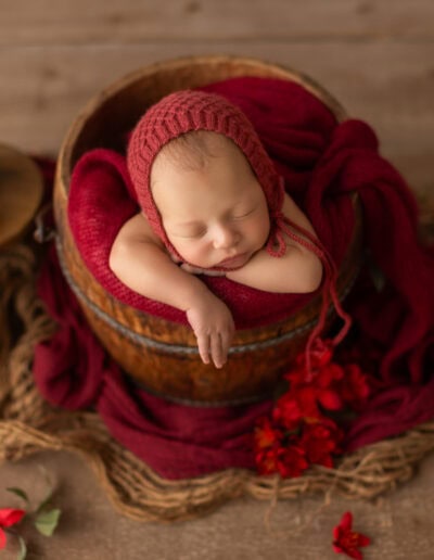 Edmonton newborn photography for a luxury and timeless look with baby in red