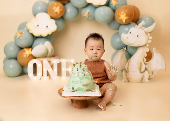 Edmonton baby smashing his first birthday cake with dragon theme