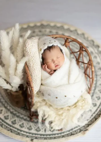 Newborn baby wrapped in white blanket